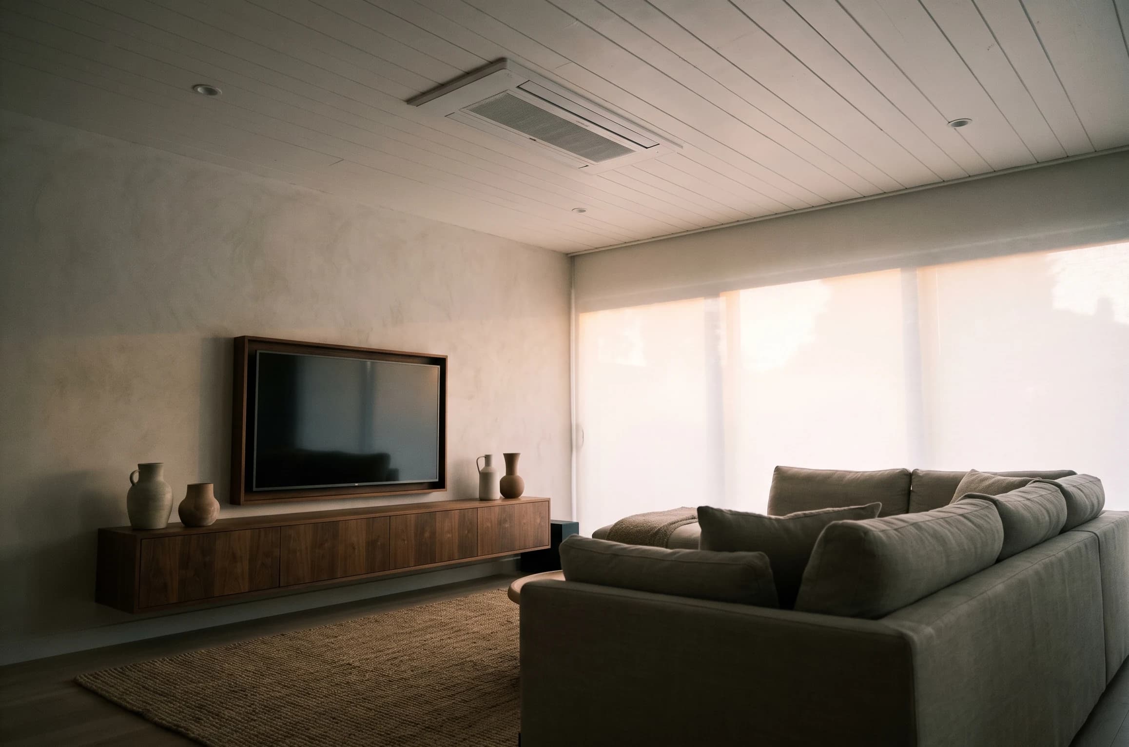 Recessed ceiling cassette flush in a shiplap ceiling over a serene media room