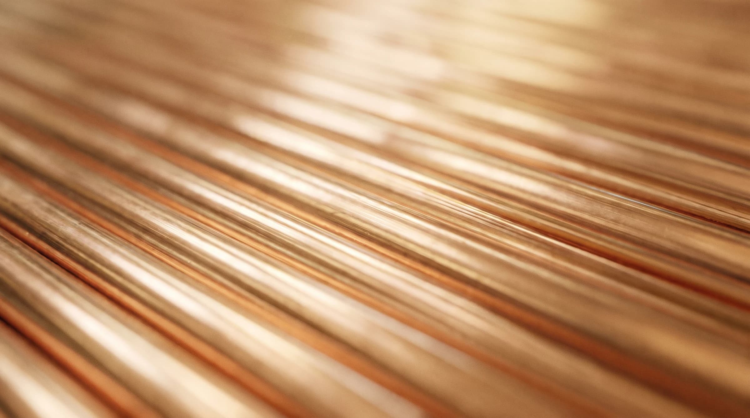 Macro of parallel copper pipe rows in warm shallow focus